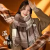 A brown checkered scarf pairs well with a beige coat for women in autumn and winter, providing warmth and fashion Specification image